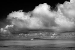 Gathering Storm. A sailboat in the Kwajalein Lagoon by Lee Craker 